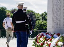 Two U.S. Marines prepare to lay down wreaths during a Memorial Day ceremony at Luxembourg American Cemetery, Luxembourg, May 23, 2026. The laying of the wreath served as a visible expression of remembrance, contributing to the continued tradition of honoring those whose names are etched in history through their service. (U.S. Air Force photo by Senior Airman Vaughn Weber)