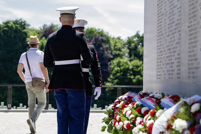 Two U.S. Marines prepare to lay down wreaths during a Memorial Day ceremony at Luxembourg American Cemetery, Luxembourg, May 23, 2026. The laying of the wreath served as a visible expression of remembrance, contributing to the continued tradition of honoring those whose names are etched in history through their service. (U.S. Air Force photo by Senior Airman Vaughn Weber)