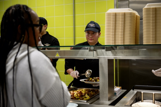 U.S. Air Force Airman 1st Class Natalie Harris, 786th Force Support Squadron food services specialist, fills a plate of food for a member of the Kaiserslautern Military Community at Ramstein Air Base, May 3. The mission of the 786th FSS is focused on readiness, personnel services and morale. Photo by Senior Airman Vaughn Weber