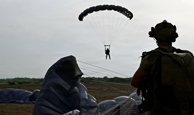 Members of the 406th Air Expeditionary Wing conduct evening military freefall training over Djibouti, May 2, 2026. Operating from the African continent requires highly adaptable forces capable of projecting rescue support across distances at a moment's notice. (U.S. Air Force photo by Master Sgt. Carlin Leslie)