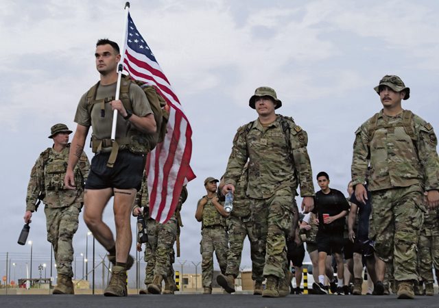 Service members deployed to Camp Lemonnier participate in a 5K memorial ruck during National Police Week at Camp Lemonnier, Djibouti, May 16, 2026. National Police Week honors law enforcement personnel currently serving while remembering those who lost their lives in the line of duty. The event, coordinated by the 726th Expeditionary Mission Support Squadron, promoted camaraderie and paid tribute to fallen defenders. (U.S. Air Force photo by Senior Airman Luis Gomez)