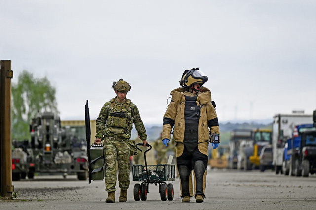 U.S. Air Force Senior Airman Cameron Poe, left, 786th Civil Engineer Squadron explosive ordnance disposal team member and Staff Sgt. Christian Brown, 786th CES EOD team leader, walk towards a simulated improvised explosive device at Ramstein Air Base, Germany, May 28, 2026. EOD forces provide full-spectrum response capability to incidents involving chemical, biological, radiological and nuclear hazards during contingencies to validate a unit's ability to scale that response across the European theater. (U.S. Air Force photo by Senior Airman Dylan Myers)