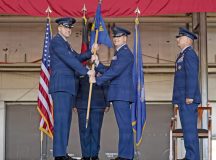 U.S. Air Force Col. Denny R. Davies, 86th Airlift Wing commander, transfers command of the 86th Logistics Readiness Group to Col. Benjamin J. Schneider, 86th LRG incoming commander, during a change of command ceremony at Ramstein Air Base, Germany, July 10, 2026. The transfer of the guidon symbolizes the formal assumption of command and responsibility for the unit and its mission. (U.S. Air Force photo by Senior Airman Olivia Sampson)