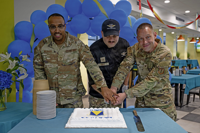 U.S. Air Force Chief Master Sgt. Ronald Weaver, left, 86th Security Forces Squadron senior enlisted leader, Airman 1st Class Cody Danz, 786th Force Support Squadron food service journeyman, and Col. Jason Schenck, 86th Mission Support Group commander, cut a cake during Ramstein Air Base's 74th anniversary celebration at the Rheinland Dining Facility on Ramstein Air Base, Germany, Aug. 5, 2026. The event commemorated the installation's history, beginning with the opening of Landstuhl Air Base in 1952 before the installation became officially known as Ramstein Air Base in 1958. (U.S. Air Force photo by Senior Airman Edgar Grimaldo)