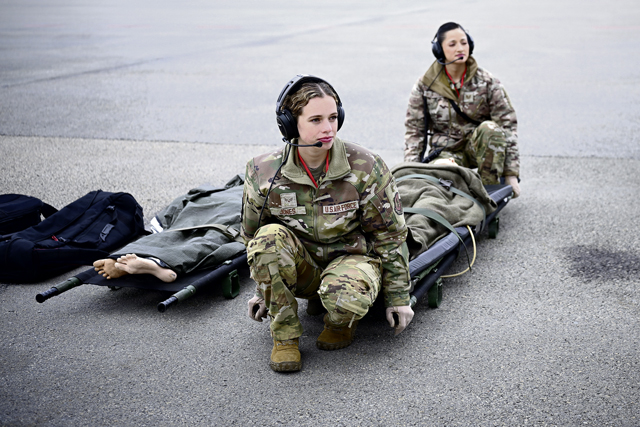 U.S. Air Force Senior Airman Rogan Jones, 86th Aeromedical Evacuation Squadron aeromedical evacuation technician, left, and U.S. Air Force Tech. Sgt. Diandra Velasquez, 86th Aeromedical Evacuation Squadron aeromedical evacuation technician, prepare to carry a litter onto an aircraft during exercise Northern Viking 26 at Keflavík Air Base, Iceland, Aug. 26, 2026. NV26 strengthens interoperability and force readiness among the U.S., Iceland and Allied nations, enabling multi-domain command and control of joint and coalition forces defending Iceland and defending the increasingly contested Arctic and North Atlantic. (U.S. Air Force photo by Staff Sgt. Johnny Foister)